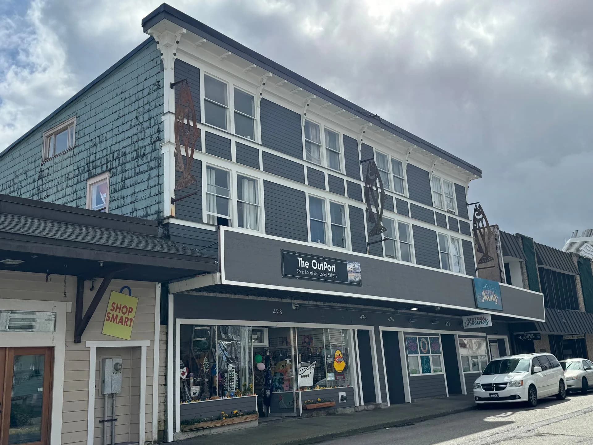 Gray multi-story building with shops on the ground floor in Ketchikan
