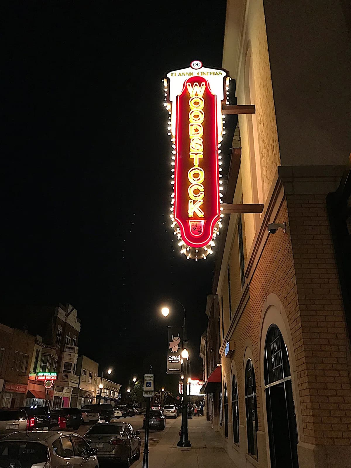 A neon sign that says ' Woodstock' on it