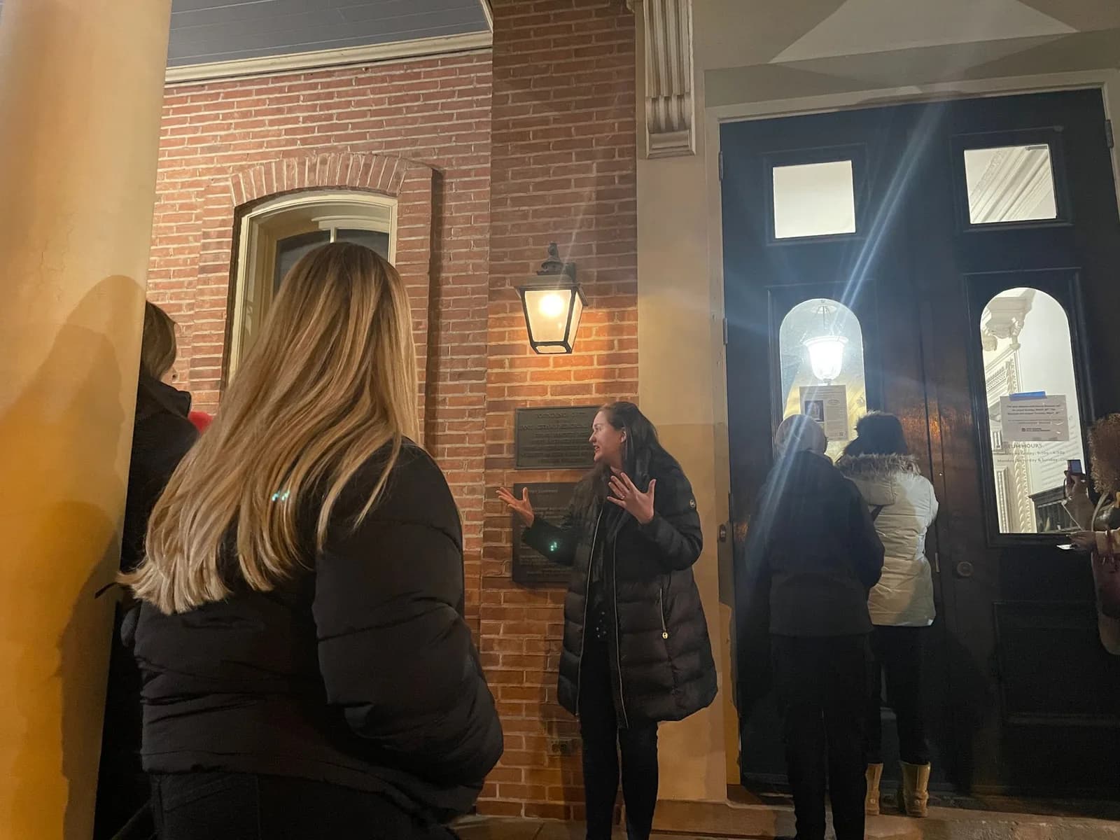 A group of people are standing outside of a building