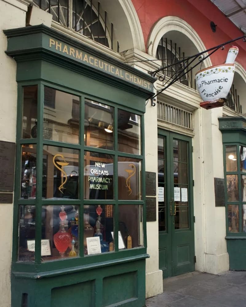 The front of a pharmaceutical store with a green awning