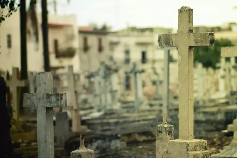 A cemetery with a lot of crosses and graves.