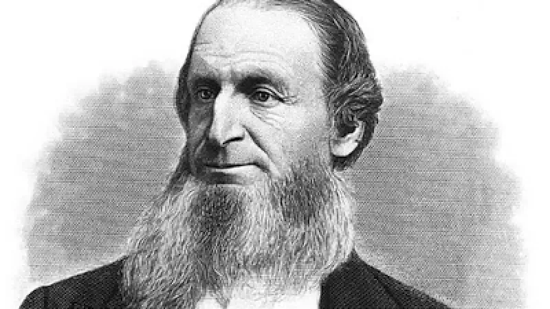 A black and white photo of a man with a long beard.