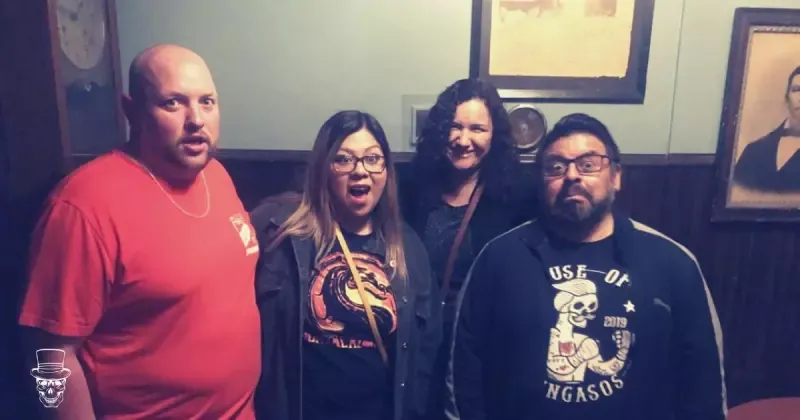 A group of people are standing next to each other in a room.
