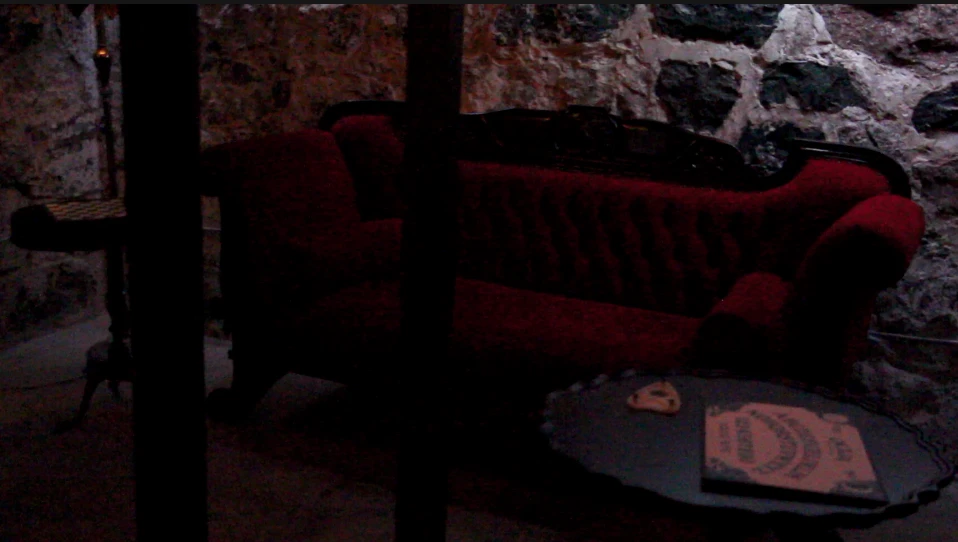 Ouija Board by a couch in the Speakeasy Bar