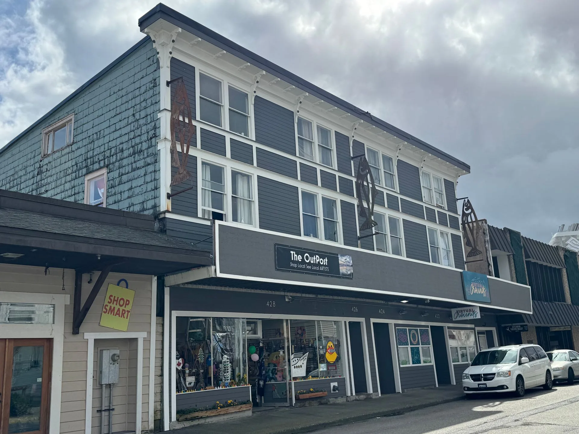 Gray multi-story building with shops on the ground floor in Ketchikan