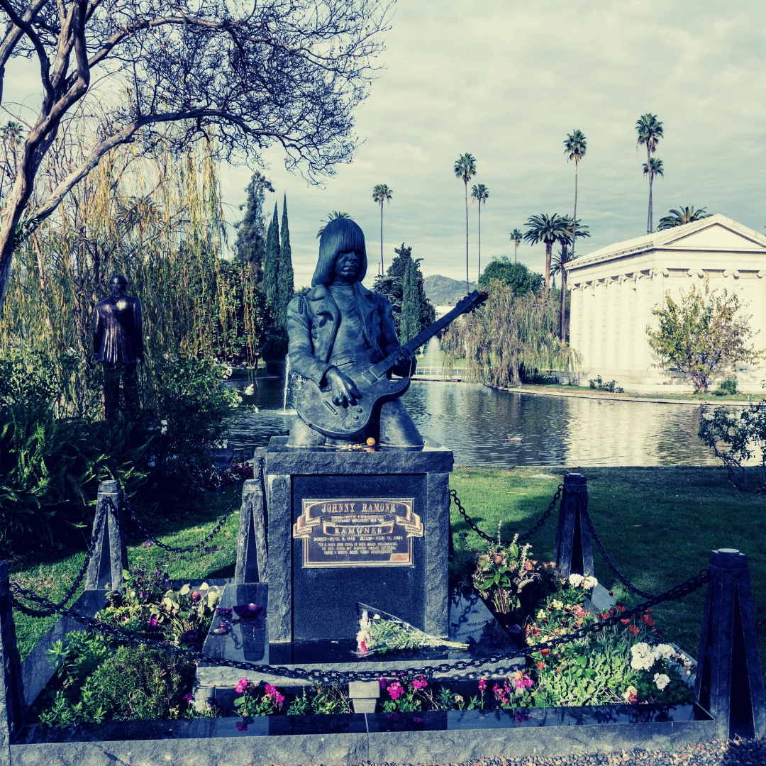 Hollywood forever cemetery has a statue of a man holding a guitar