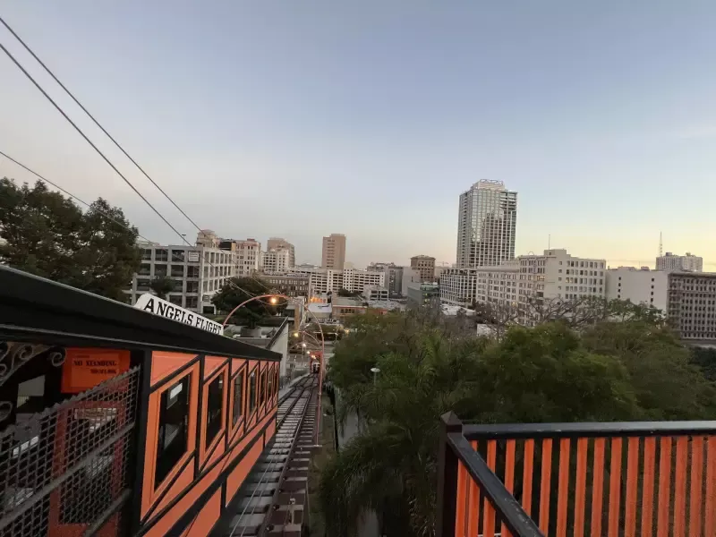 A train is going down the tracks in a city