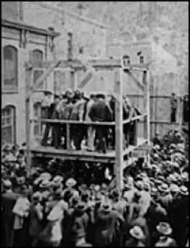 A black and white photo of a crowd watching a hanging