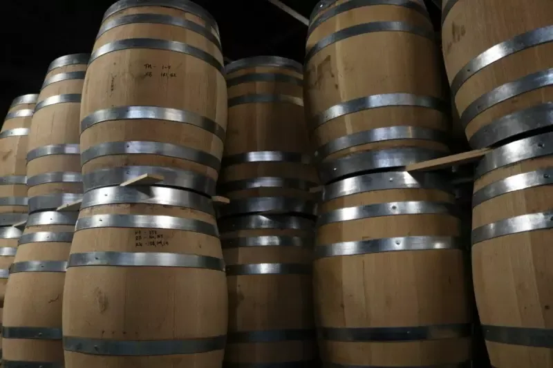 A bunch of wooden barrels stacked on top of each other