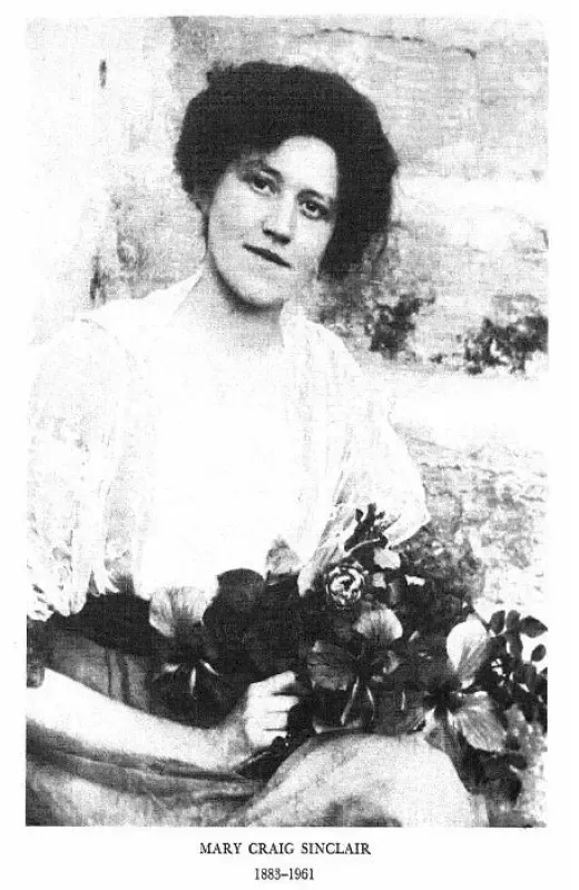 A black and white photo of a woman holding flowers