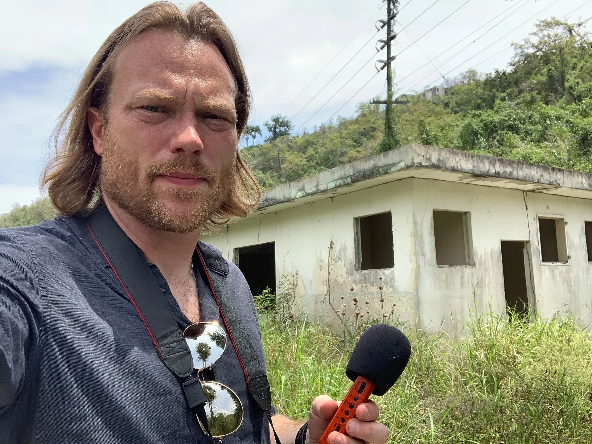 Mike Huberty investigating a haunted schoolhouse on a hillside in Puerto Rico