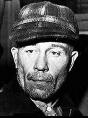A black and white photo of a man with a beard wearing a hat.