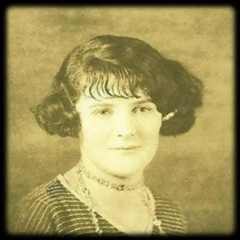 A black and white photo of a woman wearing a choker and a striped shirt.