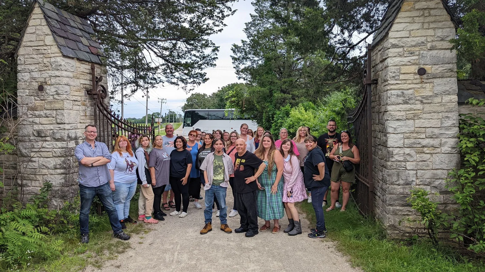 A group of people are posing for a picture in front of a building that says lake county ghost tour