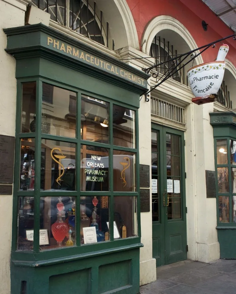 The front of a pharmaceutical store with a green awning