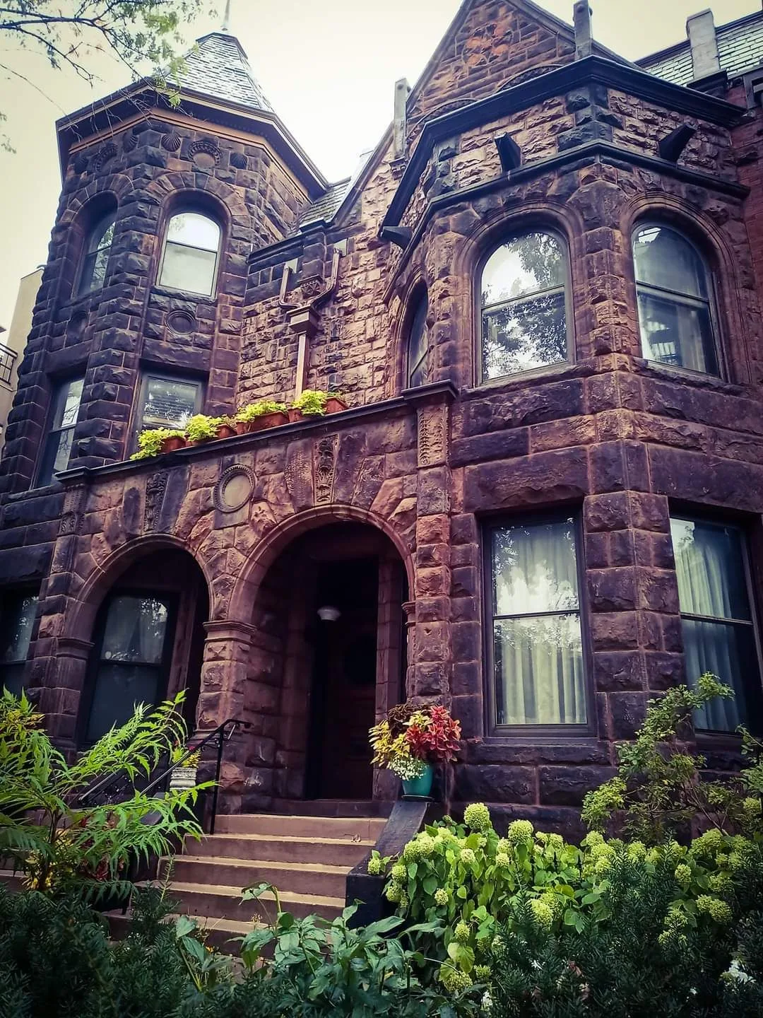 A large brick building with arched windows and stairs