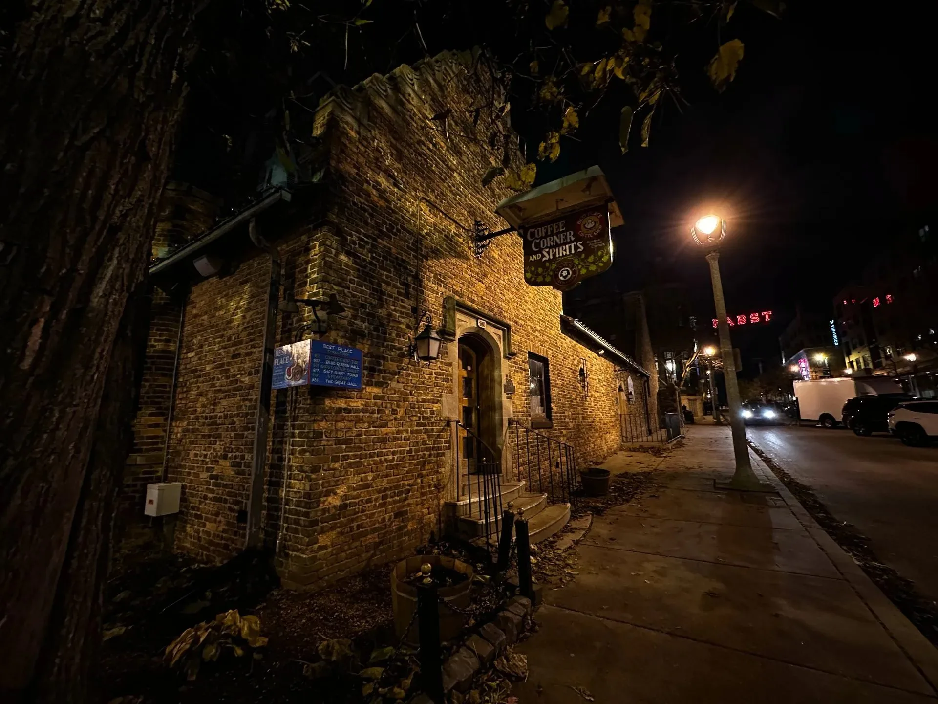 Historic brick building with Coffee Corner and Spirits sign at night